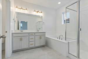 Bathroom featuring plus walk in shower and vanity