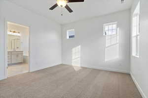 Carpeted empty room with ceiling fan