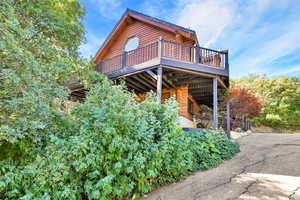 View of front of home featuring a wooden deck