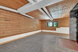 Interior space with carpet and wood ceiling