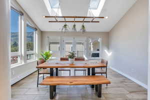 Bright dining room with skylights that goes out onto the balcony