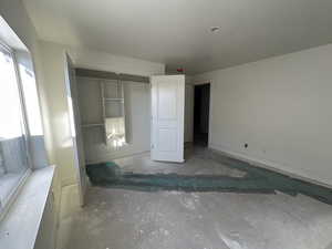 Unfurnished bedroom featuring a textured ceiling and a closet