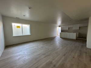 Unfurnished living room with light hardwood / wood-style floors