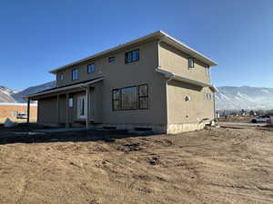 Rear view of house featuring a mountain view