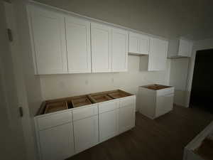 Kitchen featuring a center island, white cabinets, and hardwood / wood-style flooring