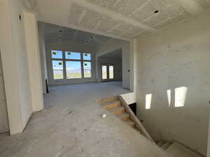 Hallway featuring french doors and vaulted ceiling