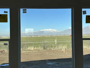 Doorway with a mountain view and a rural view