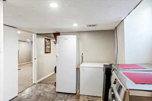 Washroom featuring a textured ceiling