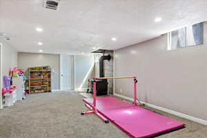 Game room featuring carpet floors and a textured ceiling