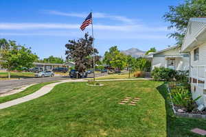 View of community with a mountain view and a lawn