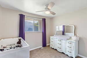 Bed 2 Carpeted bedroom featuring ceiling fan