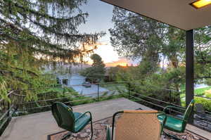 Patio terrace at dusk featuring a balcony