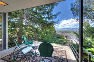 View of patio featuring a balcony and a mountain view