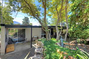 Rear view of property featuring a patio area and a mountain view