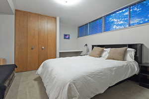 Carpeted bedroom featuring a closet