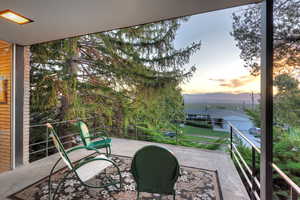 Patio terrace at dusk with a balcony and a mountain view