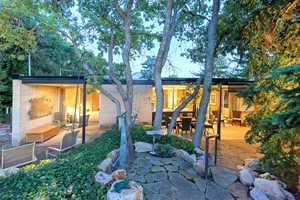 Back of property featuring a fireplace and a patio