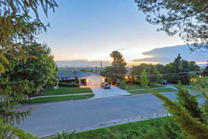 Exterior space with a garage, a yard, and a mountain view