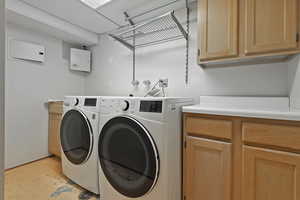 Laundry area featuring cabinets and independent washer and dryer