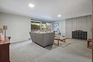 Carpeted living room with a fireplace