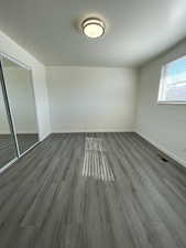 Empty room with hardwood / wood-style floors