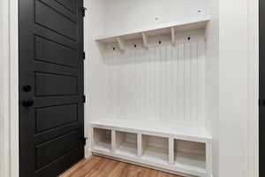 Mudroom with light hardwood / wood-style floors