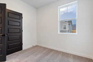 Unfurnished room with light colored carpet