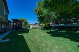 View of yard with a pergola and central air condition unit