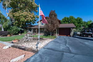 View of front of home with a garage and a front yard