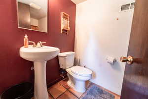 Bathroom with tile patterned floors and toilet