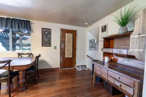 Interior space featuring dark hardwood / wood-style floors and a textured ceiling