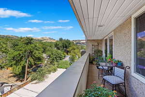 The balcony offers a charming outdoor space for relaxation, with stunning mountain views and views of the surrounding Avenues neighborhood