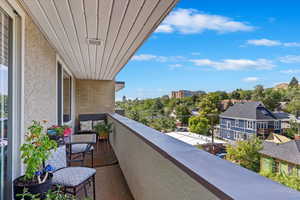 The balcony offers a charming outdoor space for relaxation, with stunning mountain views and views of the surrounding Avenues neighborhood