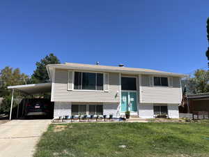 Split Entry featuring a front yard and a carport