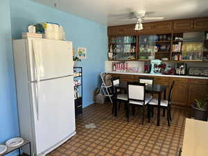 Kitchen featuring cabinets, ceiling fan & patterned floors