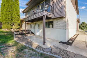 View of side of property with a patio area and a balcony