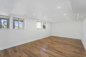 Spare room featuring hardwood / wood-style flooring and a healthy amount of sunlight