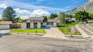 View of front of home with a front lawn and a mountain view