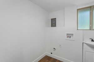 Laundry room featuring hookup for an electric dryer, washer hookup, cabinets, and dark wood-type flooring