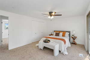 Bedroom featuring ceiling fan, light carpet, and a closet