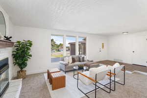 Living room featuring a textured ceiling and light wood-type flooring