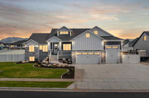 View of front facade with a garage and a yard