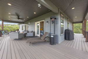 Wooden deck featuring ceiling fan and an outdoor hangout area