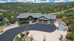 View of front of home with a mountain view and a garage