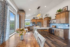 Interior space with dark hardwood / wood-style flooring, lofted ceiling, and a chandelier