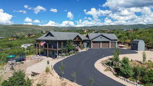 View of front of house featuring a storage unit, a garage, and a mountain view