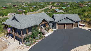 View of front of home featuring a porch and a garage