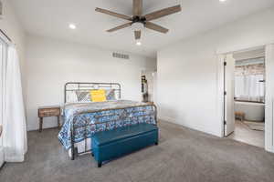 Primary Bedroom featuring ceiling fan, carpet, and ensuite bathroom