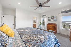 Primary Bedroom Carpeted bedroom with ceiling fan and connected bathroom