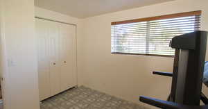 Workout room with light tile patterned flooring and a wealth of natural light